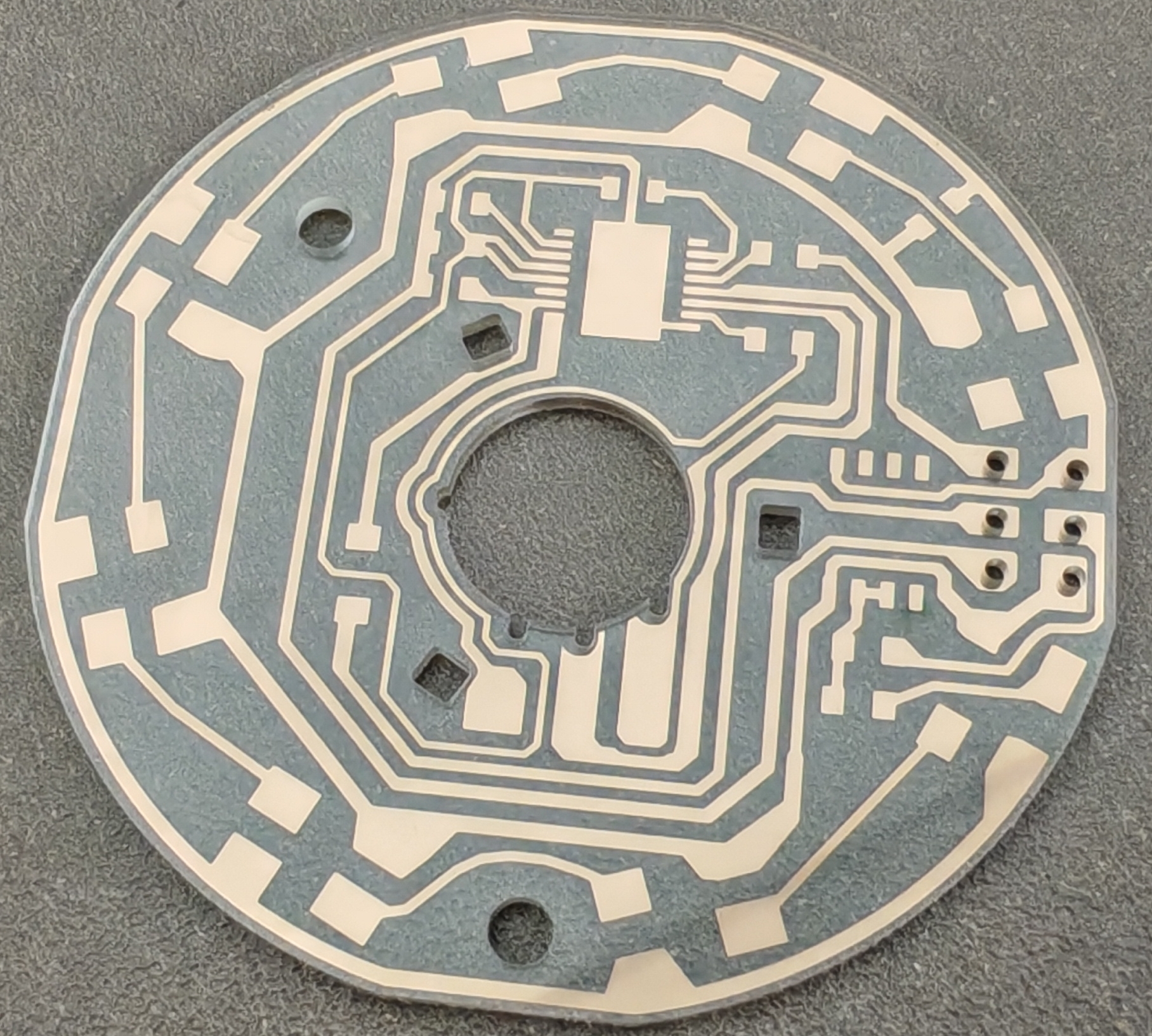 Circular glass substrate circuit board with patterned copper interconnect and mounting holes