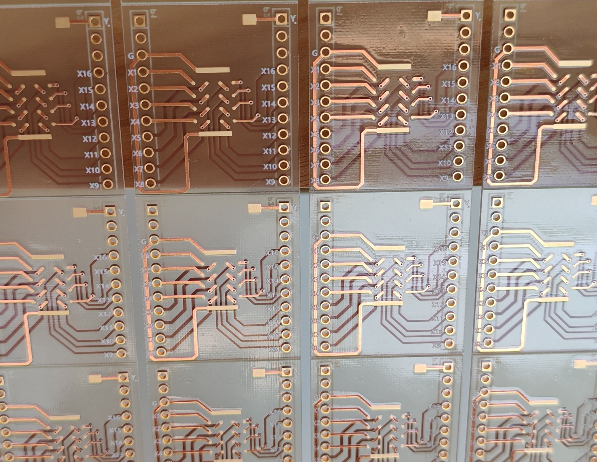 Array of transparent double-sided glass substrate circuit panels with patterned copper traces and plated holes