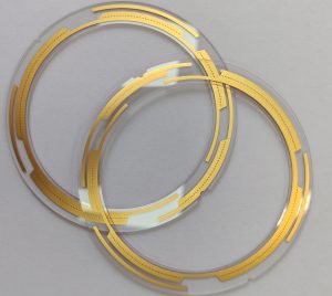 Transparent glass substrate panels with patterned gold interconnect traces, an example of glass-based circuit fabrication