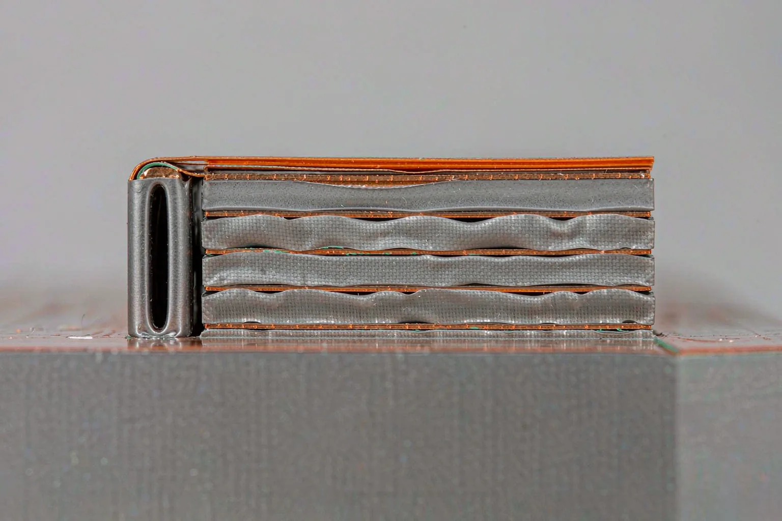 Cross-section edge view of a multilayer PCB showing alternating copper foil and laminate layers